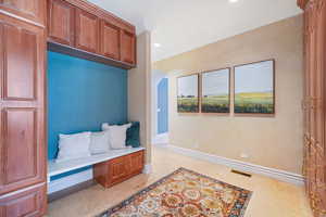 Mudroom featuring crown molding, recessed lighting, and arched walkways
