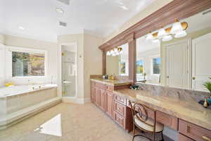 Bathroom featuring a garden tub, ornamental molding, a stall shower, vanity, and light tile patterned flooring