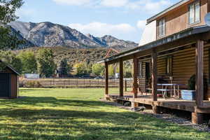 View of yard with a view of rural / pastoral area, a deck with mountain view, and a shed