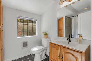 Full bath featuring vanity, heating unit, and curtained shower