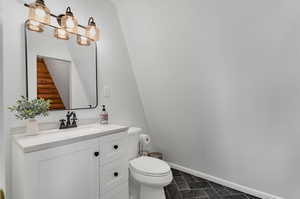 Half bath with vanity and baseboards