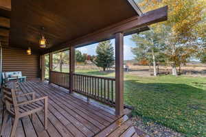 Wooden porch featuring a fenced backyard