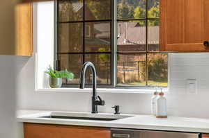 Kitchen view of tasteful backsplash and brown cabinets