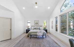 Bedroom with high vaulted ceiling, light wood-type flooring, recessed lighting, and ceiling fan