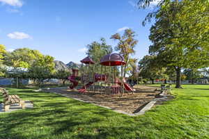 Community jungle gym with a lawn and a mountain view