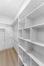 Spacious closet featuring light wood-style floors