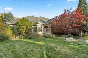 View of front of home featuring a front yard and brick siding