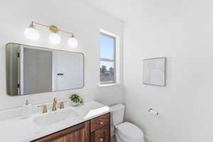 Half bath with vanity and toilet