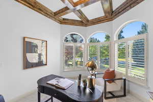 Office featuring coffered ceiling, beamed ceiling, and healthy amount of natural light