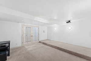 Unfurnished room with french doors, carpet floors, and recessed lighting