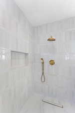 Full bath featuring tiled shower