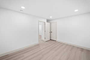 Spare room featuring light wood finished floors and recessed lighting
