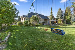 View of community with a lawn, a gazebo, a patio, and a vegetable garden
