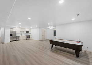 Playroom with recessed lighting and light wood-type flooring
