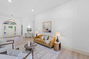Living room featuring wood finished floors, recessed lighting, and arched walkways