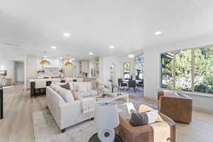 Living area featuring light wood finished floors and recessed lighting