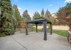 View of community featuring a patio, a gazebo, and a fenced backyard