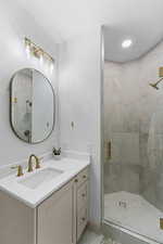 Bathroom with vanity, a stall shower, recessed lighting, and light tile patterned floors