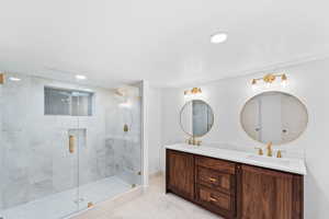 Bathroom with double vanity, a stall shower, light tile patterned flooring, and recessed lighting