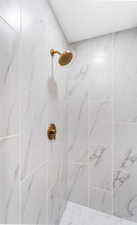 Bathroom featuring a marble finish shower