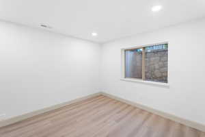 Spare room with light wood-style flooring and recessed lighting