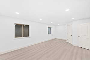 Basement featuring recessed lighting and light wood-style floors