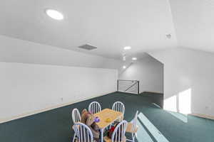 Bonus room featuring vaulted ceiling, a textured ceiling, carpet floors, and recessed lighting