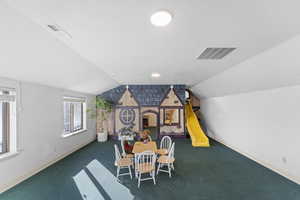Playroom with carpet floors and vaulted ceiling