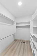 Walk in closet featuring light wood finished floors