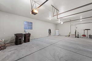 Garage with freestanding refrigerator and a garage door opener