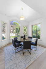 Dining room with vaulted ceiling and light wood finished floors