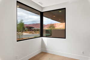 Spare room featuring a mountain view and light wood-style floors