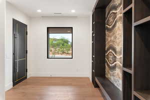Mudroom with light wood-style floors and recessed lighting