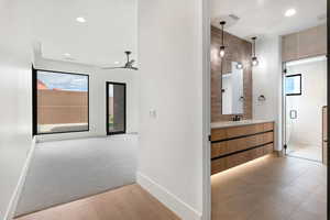 Hall featuring recessed lighting, light wood-style floors, and light colored carpet