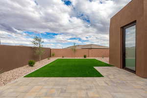 Fenced backyard with a patio area