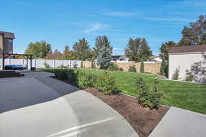 Fenced backyard with beautiful landscaping.