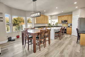 Dining room with recessed lighting and light wood-style floors