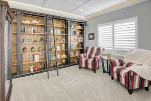 Office/Den or reception area with light colored carpet, recessed smart lighting, and coffered ceiling.