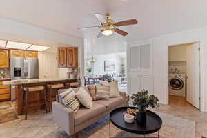 Warm and inviting, the main-floor family room features a cozy fireplace and flows effortlessly into the semi-formal dining area and kitchen—creating a functional and connected living space. Perfect for everyday living and entertaining, this open-concept