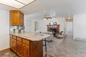 Kitchen featuring a peninsula connecting to the main floor family room area.