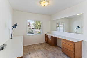 Versatile main-floor office space features custom built-in desks, offering an ideal work-from-home setup. With its generous size and convenient layout, this room can easily be converted into a bedroom to suit your changing needs, providing flexibility and