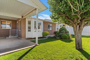 Step outside to a beautifully manicured yard that offers both curb appeal and a peaceful outdoor retreat. The lush landscaping provides the perfect backdrop for the spacious covered patio—ideal for outdoor dining, entertaining, or simply relaxing in the