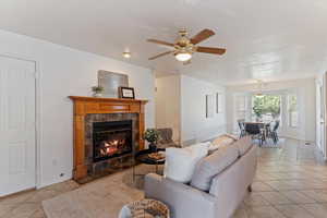 Warm and inviting, the main-floor family room features a cozy fireplace and flows effortlessly into the semi-formal dining area and kitchen—creating a functional and connected living space. Perfect for everyday living and entertaining, this open-concept