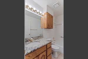 Full bathroom featuring light tile patterned floors, vanity, and shower / bathtub combination