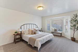 Retreat to the expansive primary bedroom, filled with natural light and designed for comfort and relaxation. This serene space features generous proportions, large windows, and direct access to a private en-suite bathroom. The attached bath offers both co