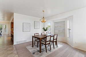 Bright and beautiful, the formal dining room seamlessly connects to the elegant formal living area, creating a perfect setting for entertaining and special gatherings. Large windows fill the space with natural light, highlighting the classic layout and re