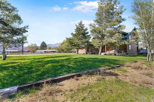 View of green lawn featuring a mountain view