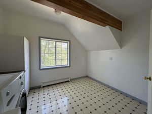 Additional living space with light flooring and a baseboard radiator