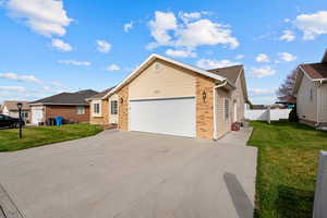 Ranch-style house with brick siding, concrete driveway, and a garage