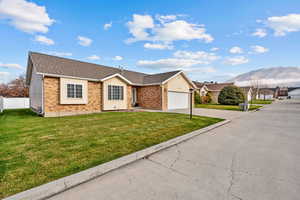 Ranch-style home featuring concrete driveway, a shingled roof, brick siding, and a garage